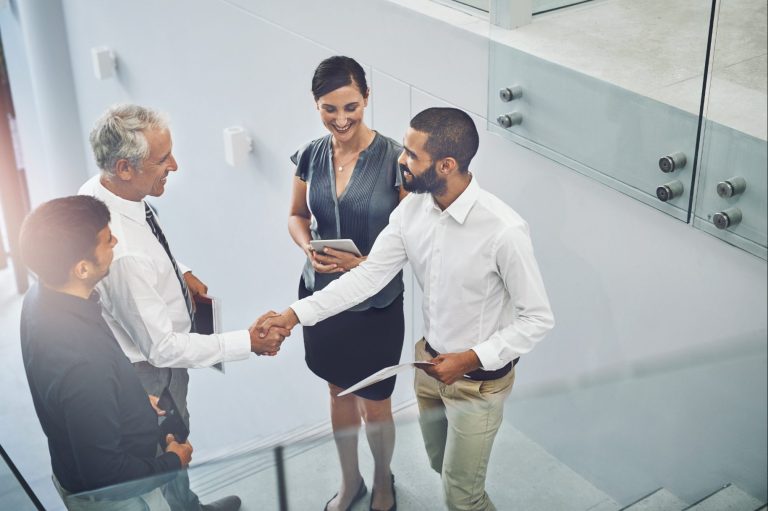 Dienstleistung für Unternehmen Silhouetten von Talenten vor einer Stadtlandschaft und blauem Himmel.